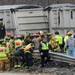 Rescue crews work to open the roof of the vehicle which was pinned under the trailer and against the guardrail. The driver of the vehicle was confirmed dead.  Melanie Maxwell I AnnArbor.com